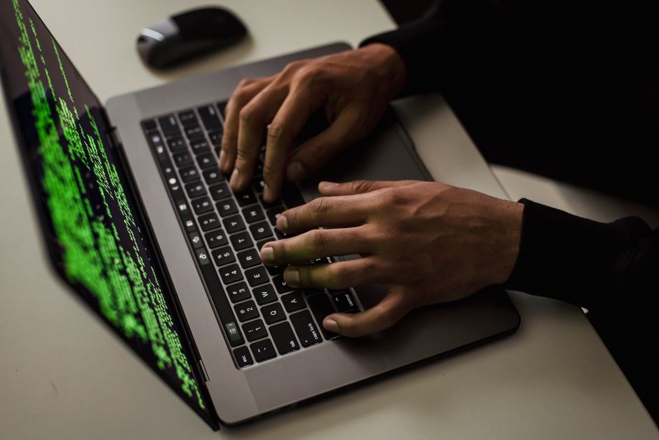 Developer reviewing code on a dual monitor setup